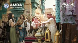 Two young women interacting with a local businessman at a souq in Al Balad the historic district in Jeddah